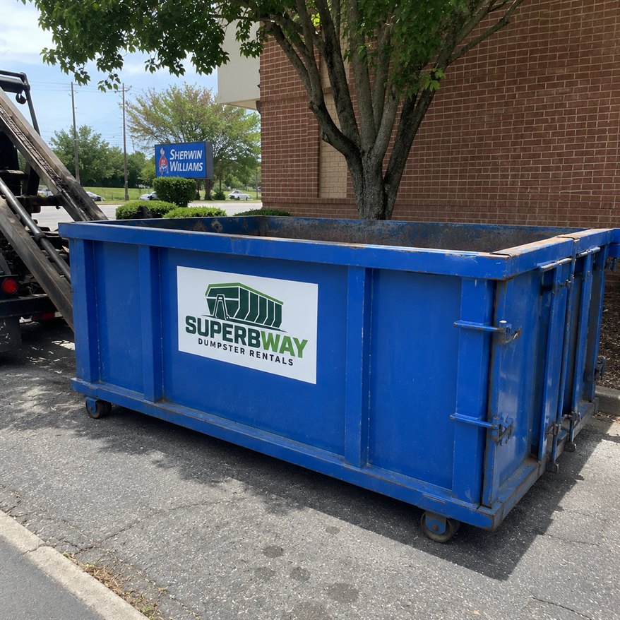 Blue Superbway roll-off container placed curbside for a commercial cleanup