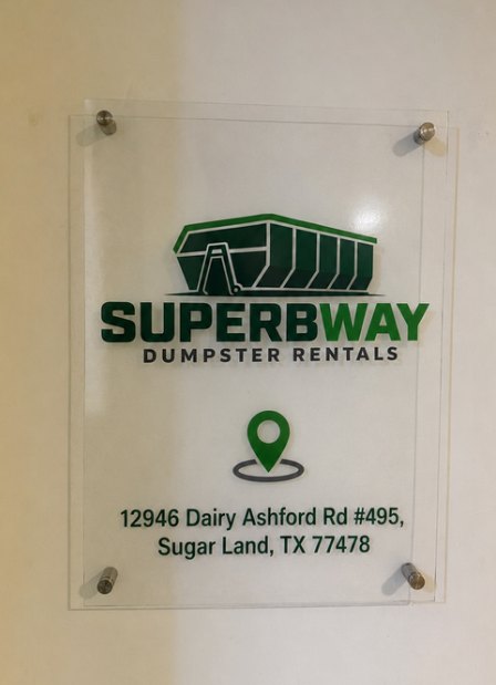 Superbway Dumpster Rentals signage mounted beside the office entrance showing the street address